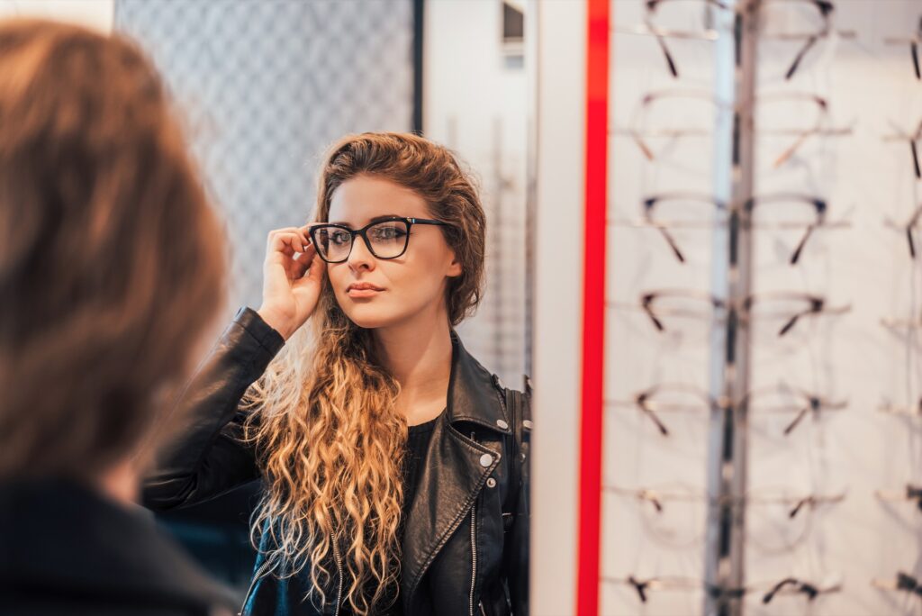 Young woman trying on new glasses prescription