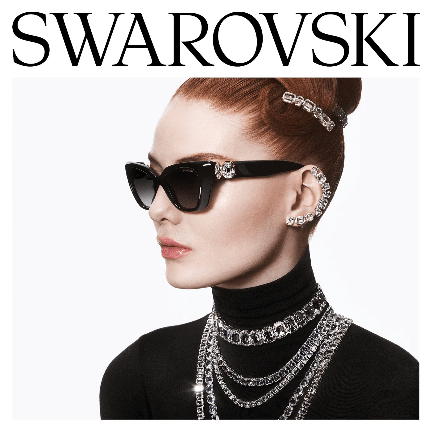 A fashion model featuring the Swarovski eyewear collection, wearing black cat-eye sunglasses and matching crystal-embellished jewelry.