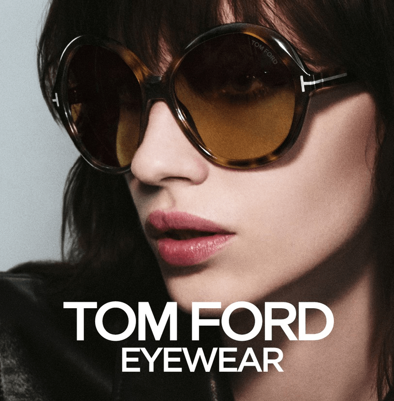 A close-up of a fashion model wearing oversized, round tortoiseshell Tom Ford sunglasses with a gradient tint.