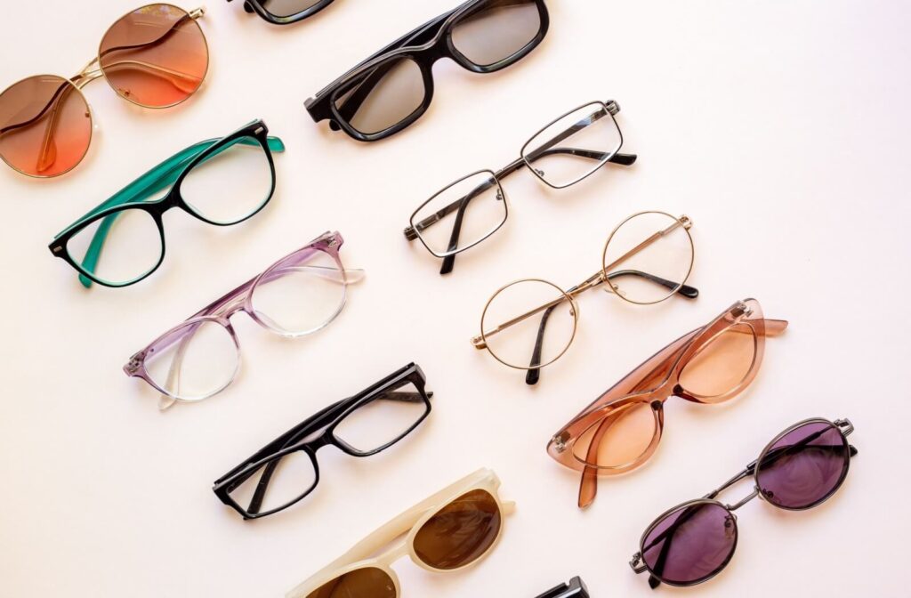 A diverse selection of trendy eyeglasses placed on a table and separated into two columns.