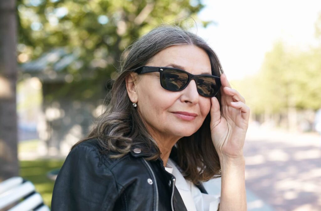 A person wearing sunglasses for light-sensitive vision.