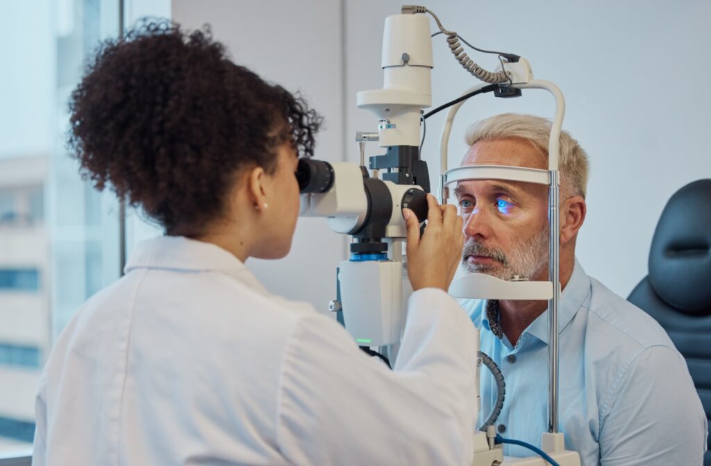 An older adult getting their eyes checked by an optometrist.