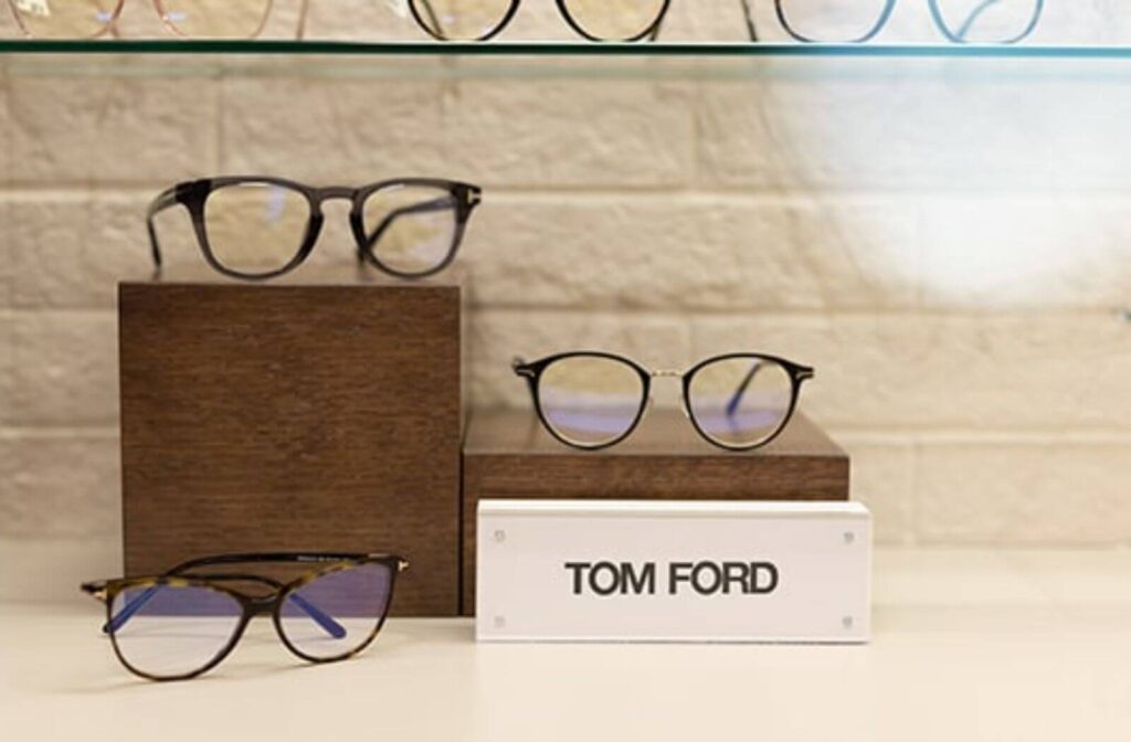 Modern eyeglass frames displayed on a retail shelf, showcasing eyewear fashion trends for 2026.